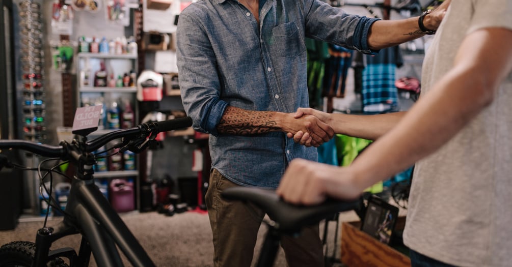 bicycle-shop-owner-shake-hands-customer-service