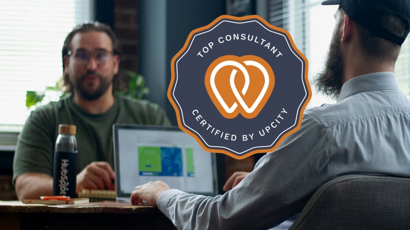 Founder Chris Nault and Automation Engineer Chris Bialek working at Growth Headquarters in Orlando with the UpCity certification badge overlay.