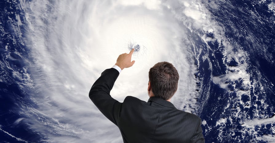 A meteorologist touches the satellite image of a hurricane eye