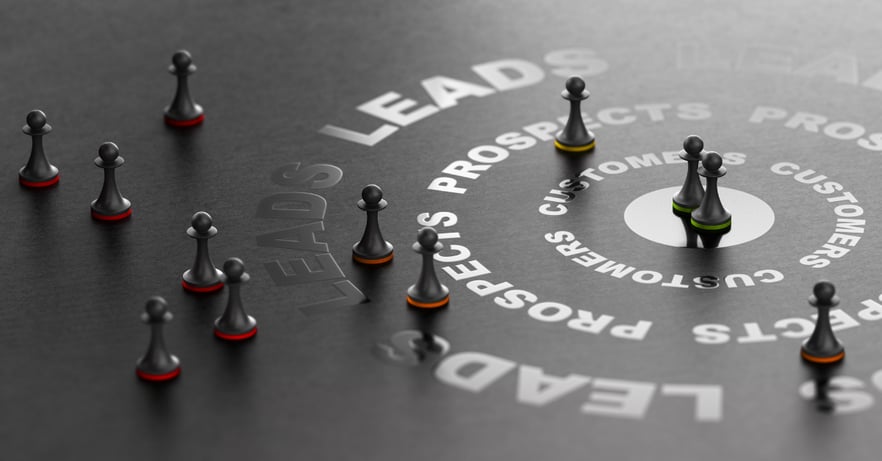 Game pieces scattered strategically around a black board with the word Leads printed in a circle to represent lead generation