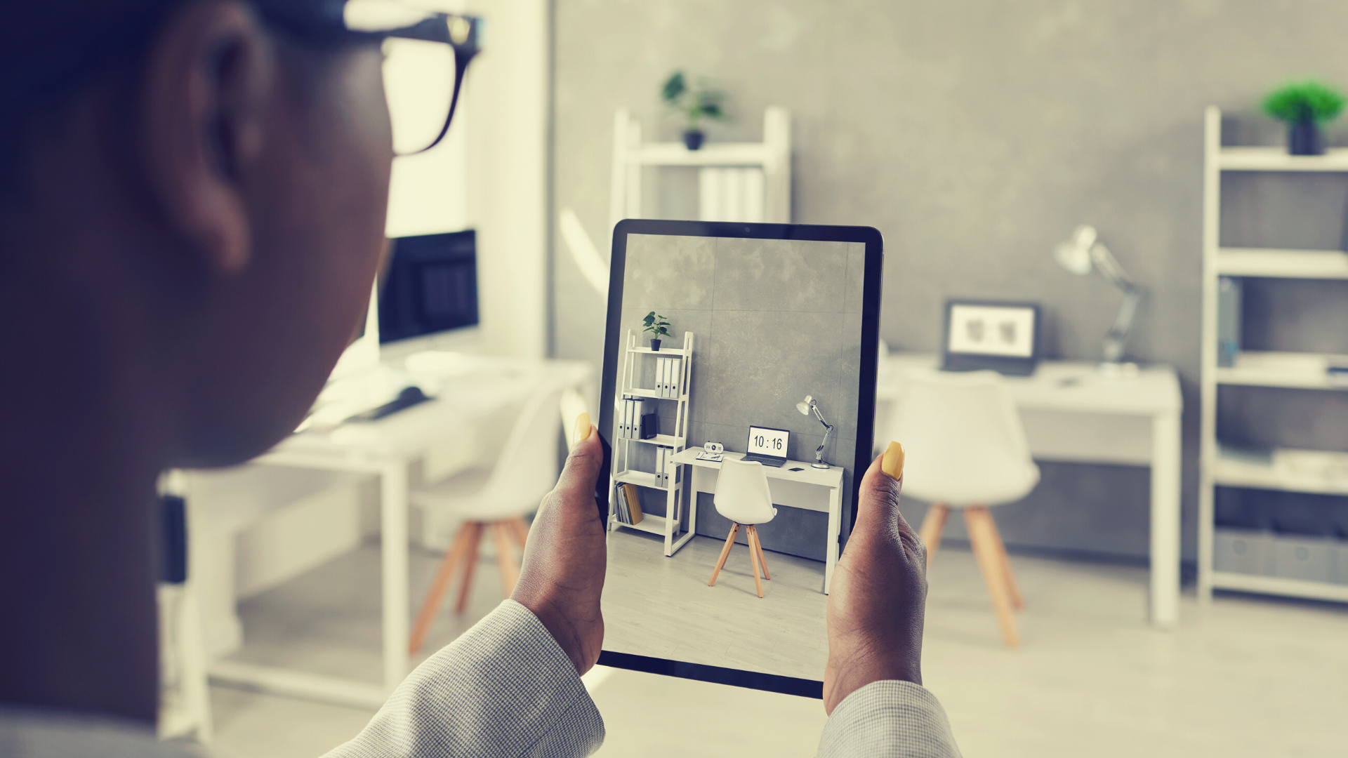 A person recording a video of their home office with their iPad. 