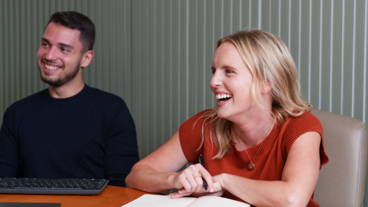 Amber and Rick from Growth laughing in the conference room