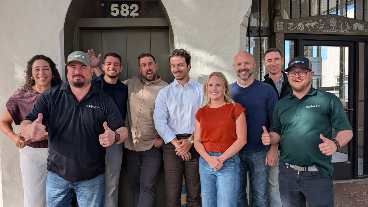 The Growth team attempting a group photo in front of the office door